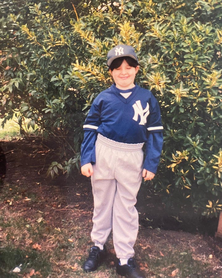 Pictures of Meg, age 8, in a softball uniform looking particularly unathletic.