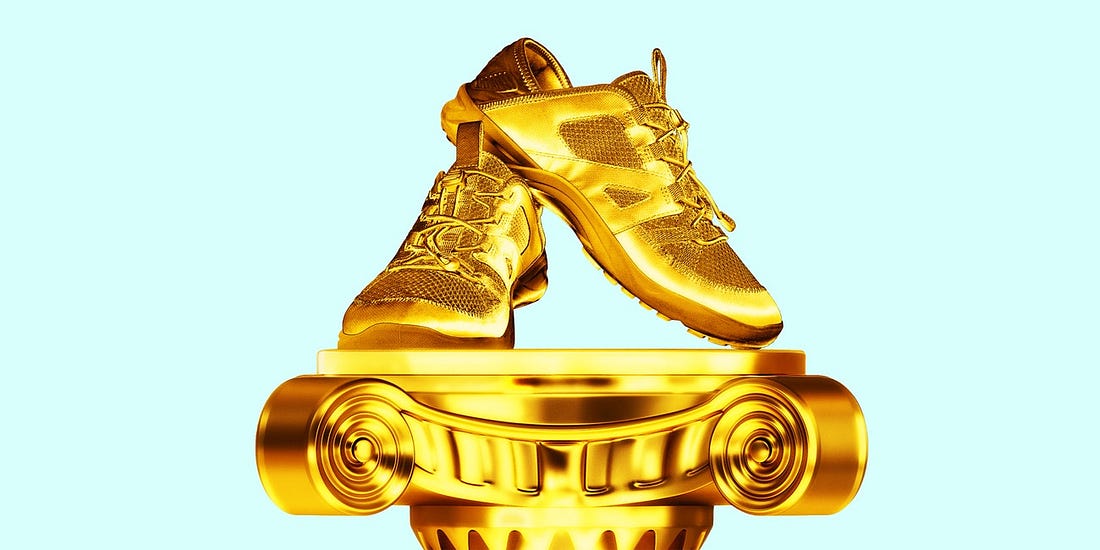 Gold running sneakers on a golden podium