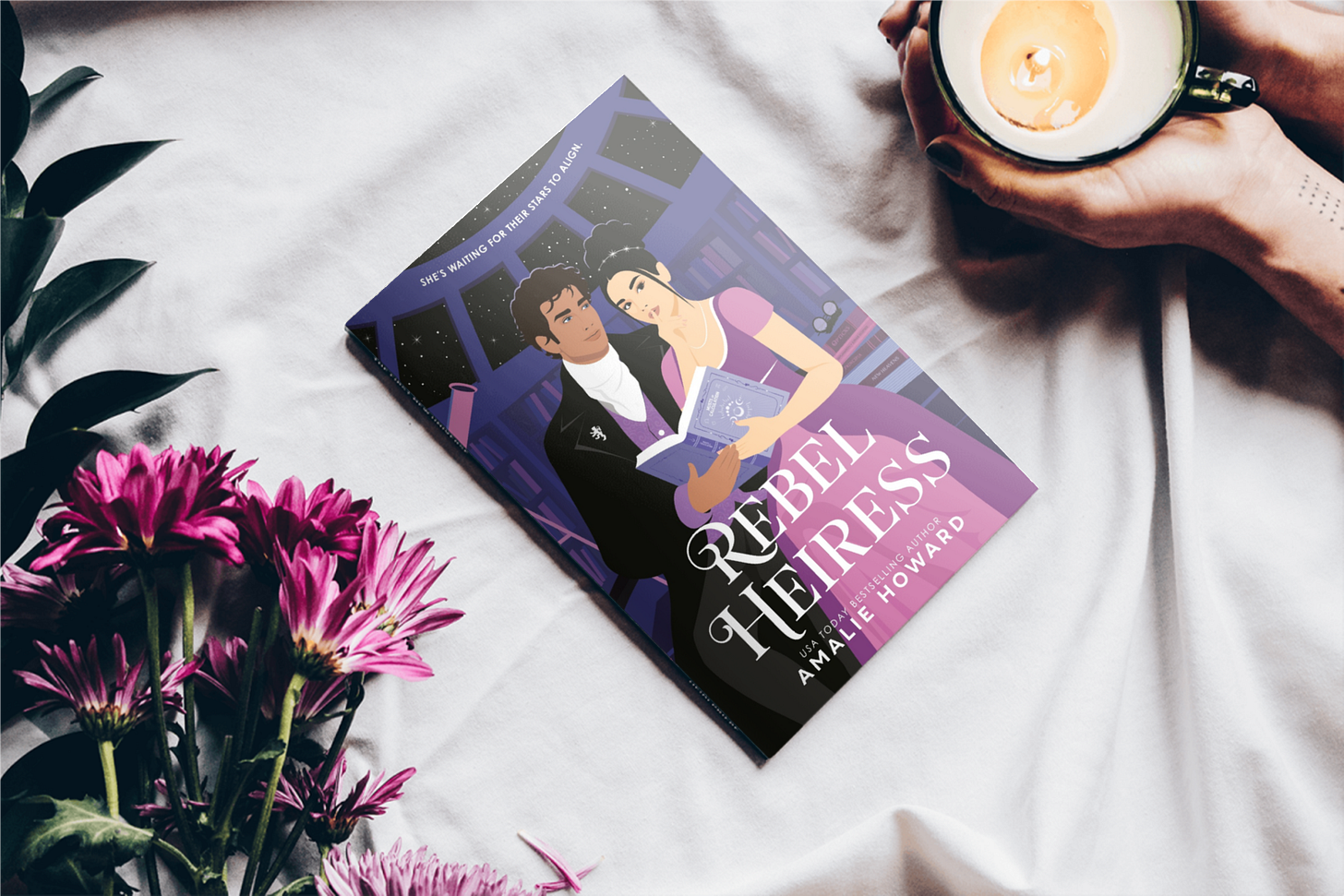 Book "Rebel Heiress" next to flowers and woman holding a teacup candle Book "Rebel Heiress" next to flowers and woman holding a teacup candle