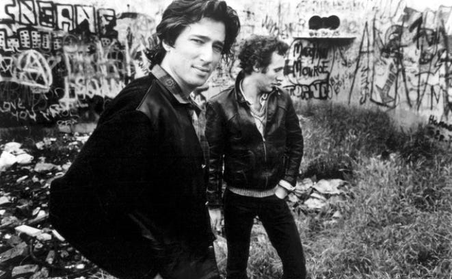 Black and white picture of David Ricketts in the foregrand and David Baerwald in the background.
