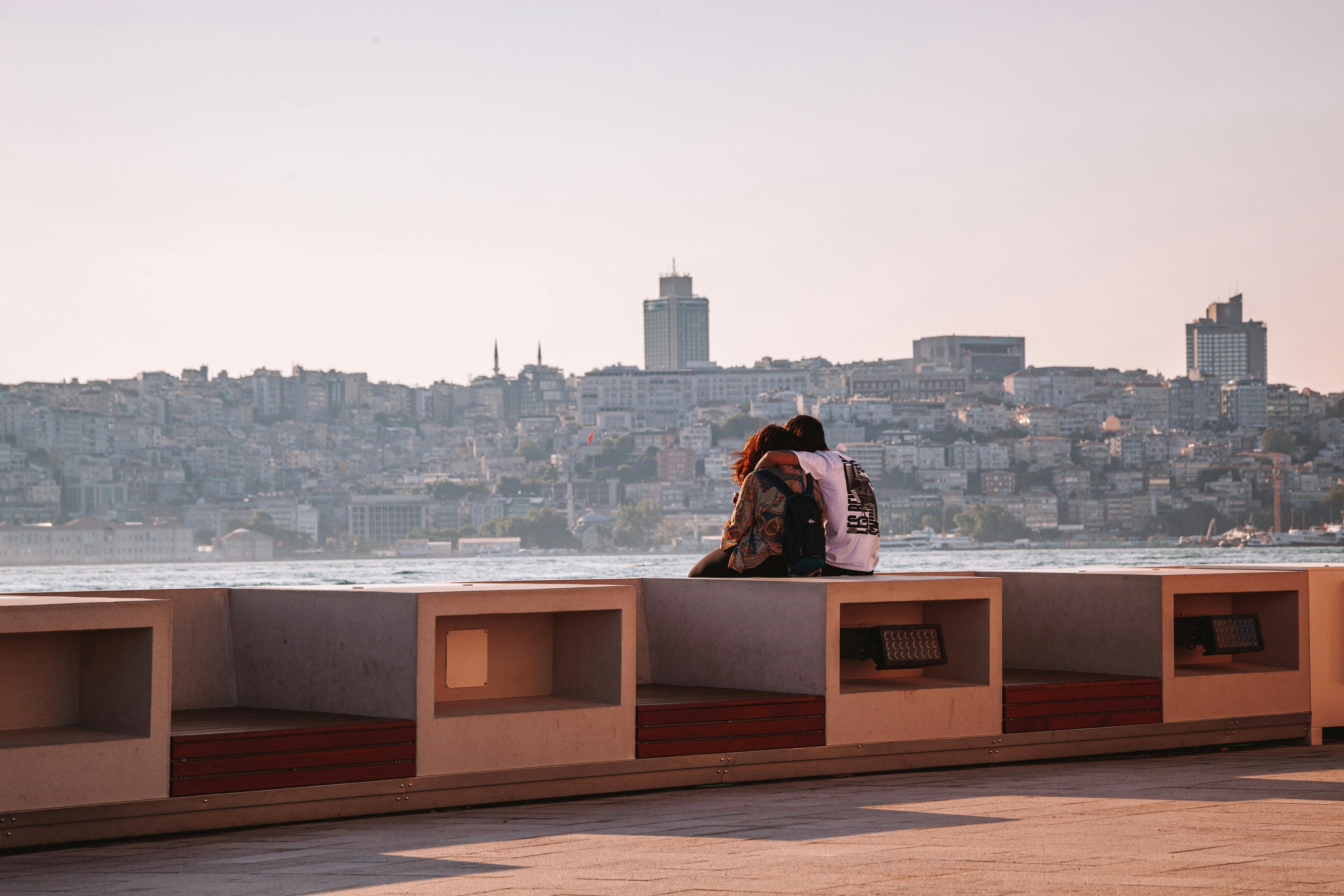 A woman and a man sit together on a pier in Istanbul, June 22, 2023. (Photo via Pexels)