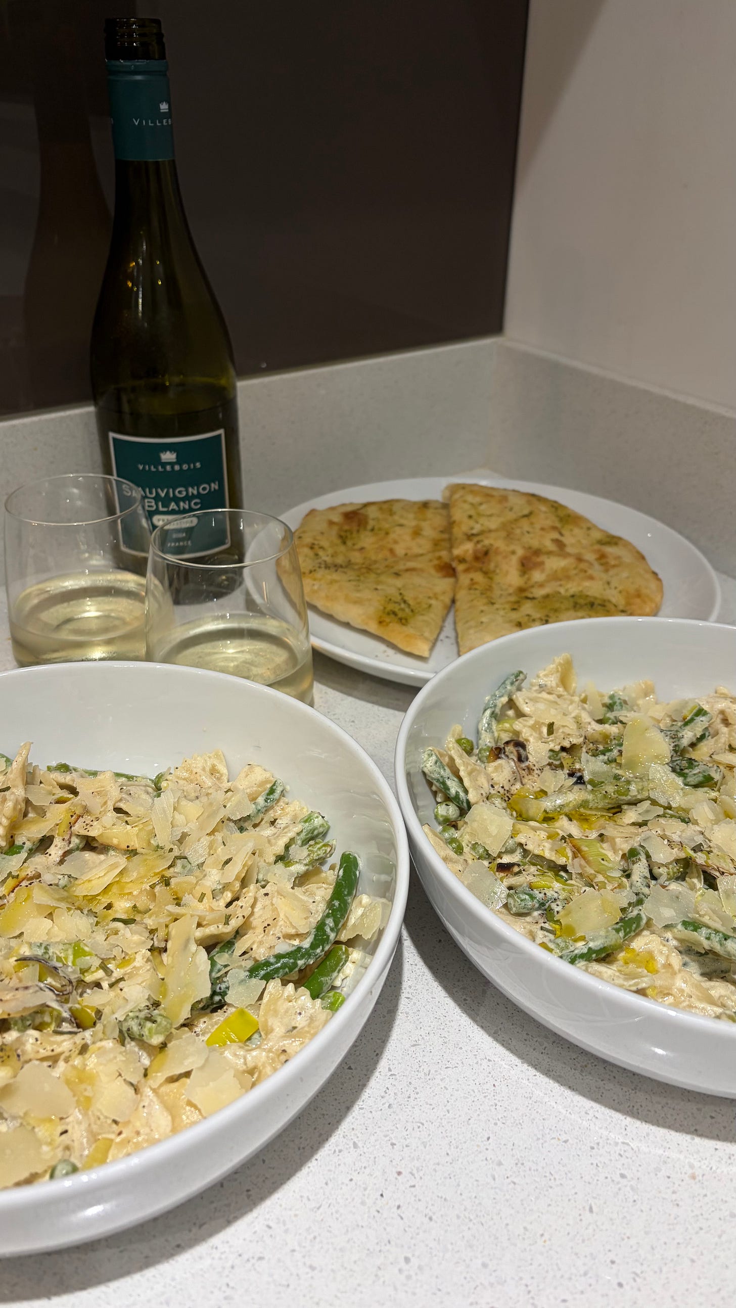 pasta primavera served wtih garlic bread and white wine