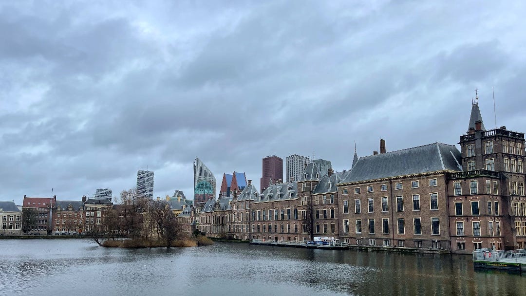 a large pond, classic buildings in the background