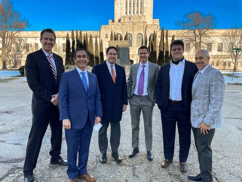 A group of men in suits

Description automatically generated with medium confidence