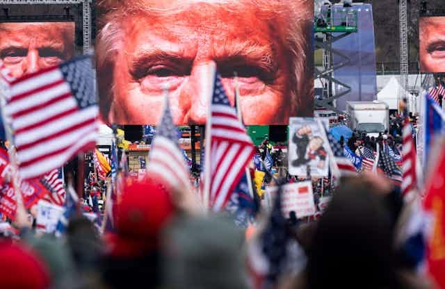 Trump supporters watch him on a big screen on January 6 2021. Trump supporters watch him on a big screen on January 6 2021.