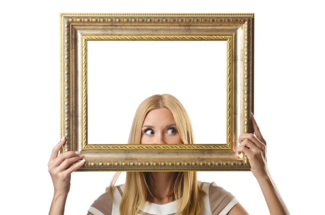 A person holding a picture frame

AI-generated content may be incorrect.