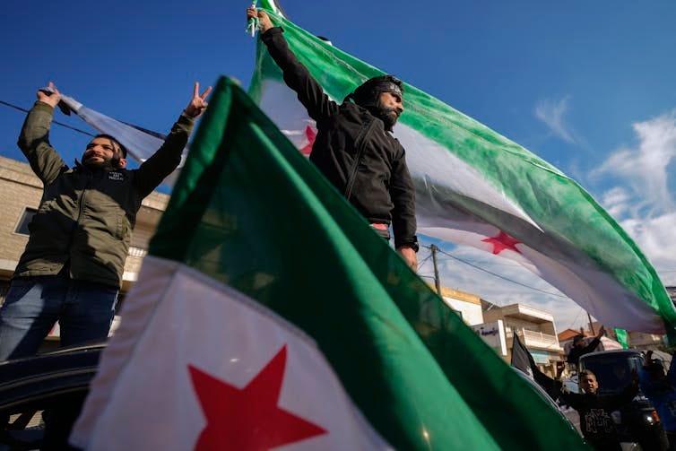 Men hold green, white and red flags. Men hold green, white and red flags.