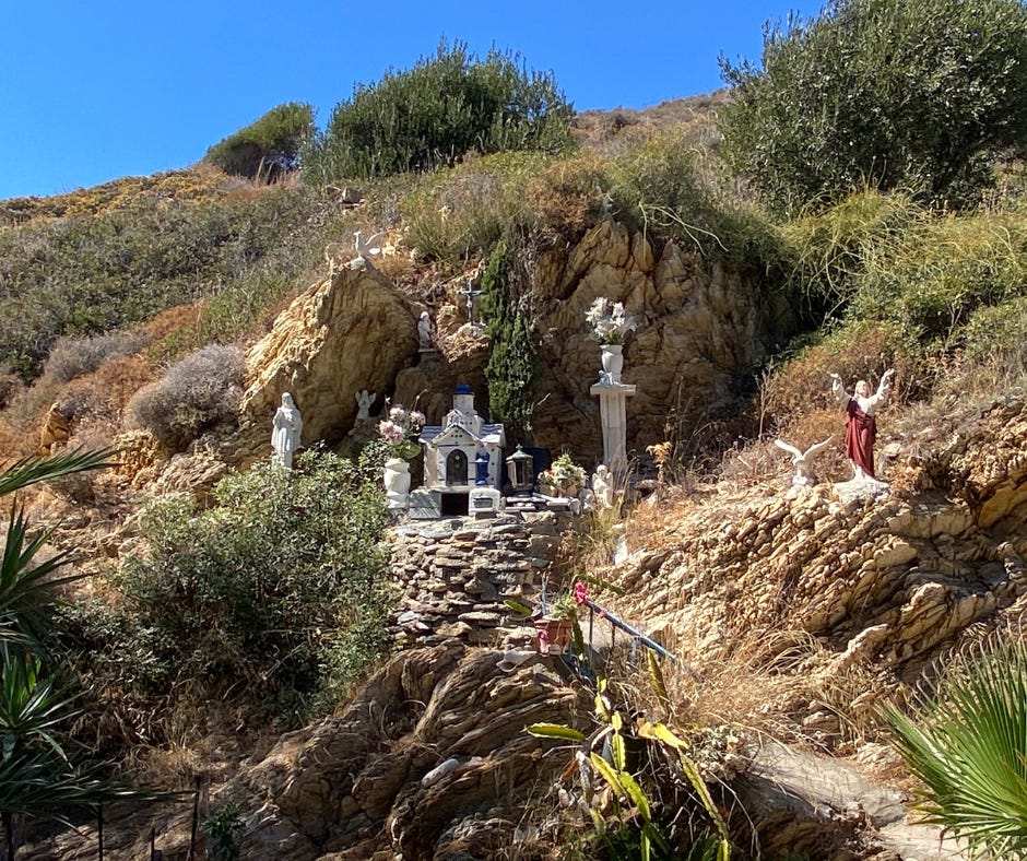 hillside shrine with Catholic religious statues on the island of Fournei