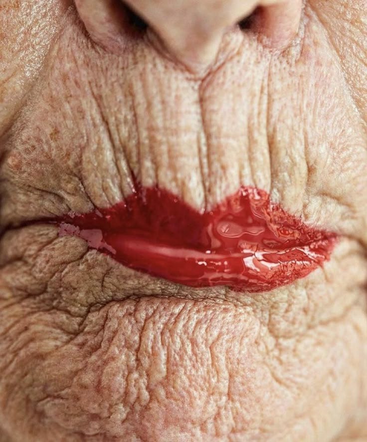 This may contain: an old woman's lips with blood on them