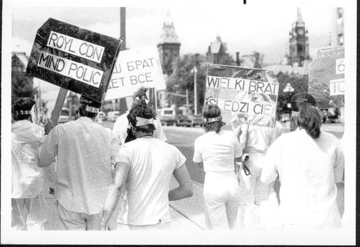 A group of people marching with signs

AI-generated content may be incorrect.