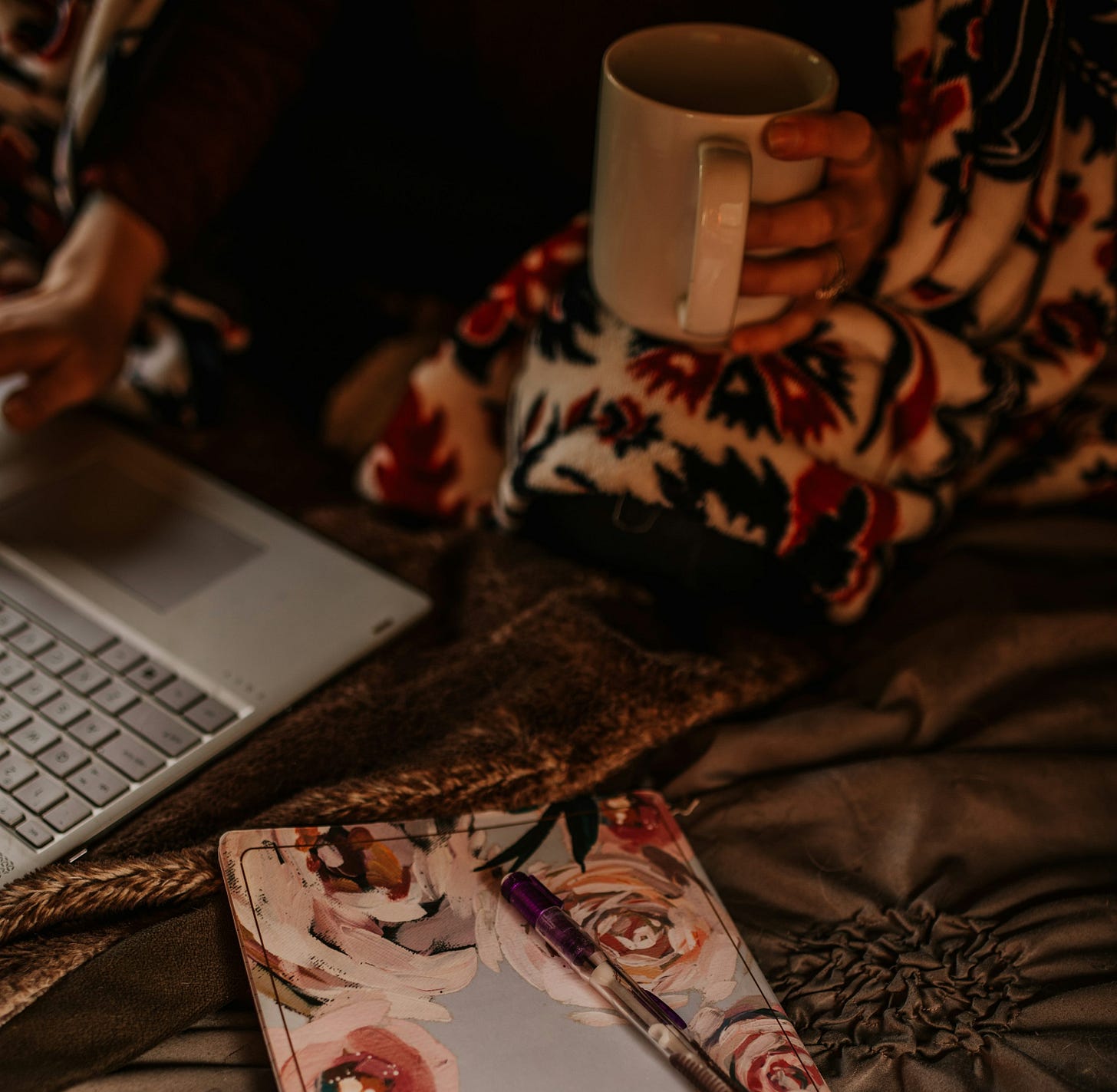 white laptop computer on brown and white floral textile white laptop computer on brown and white floral textile