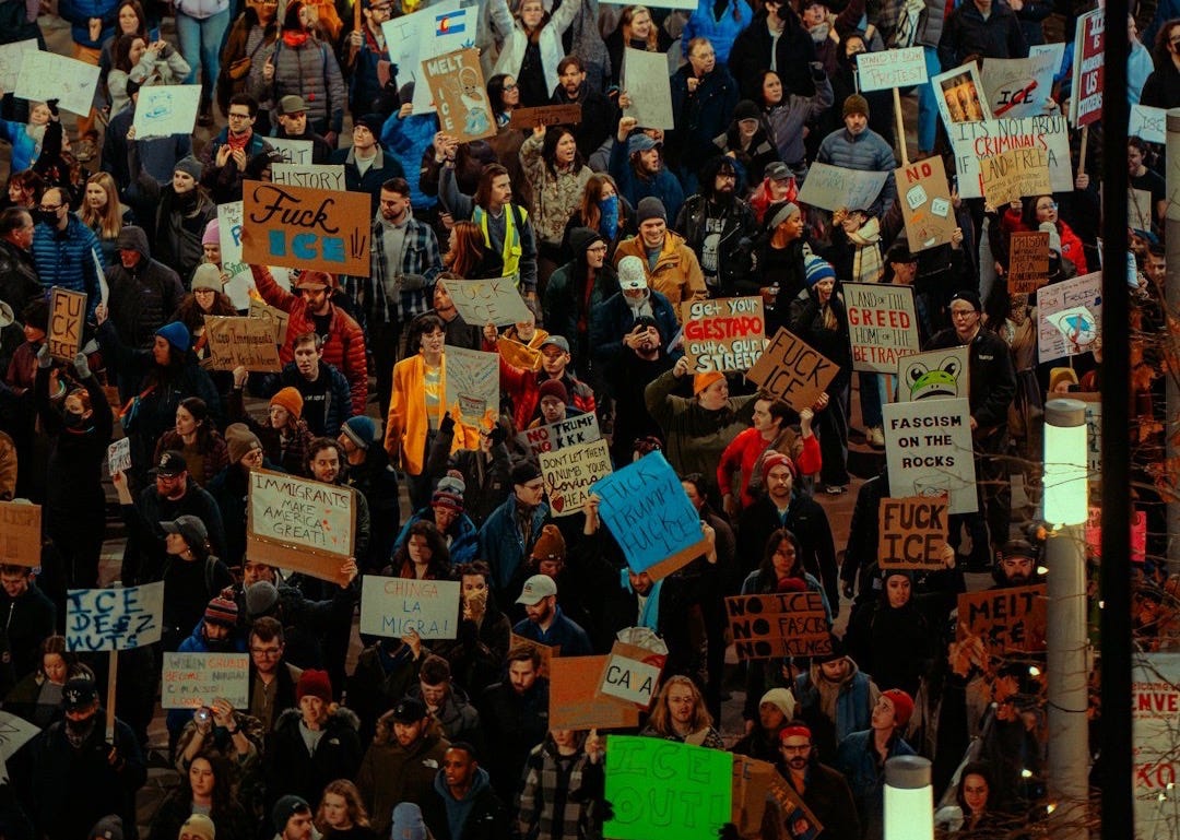 Crowd of people holding signs at a protest