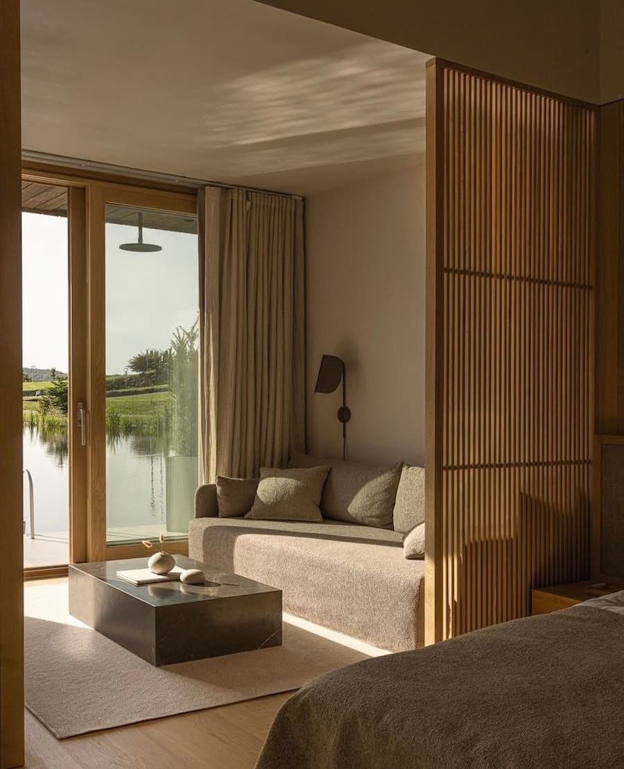 loung in neutral tones with wooden slatted room divide loung in neutral tones with wooden slatted room divide