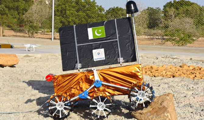 Pakistan’s lunar rover climbing a rock with its solar panel deployed, the solar cells are on the other side. Pakistan’s lunar rover climbing a rock with its solar panel deployed, the solar cells are on the other side.