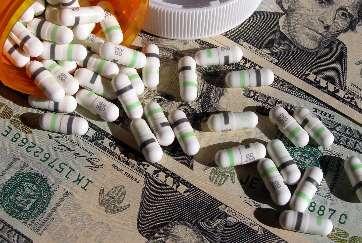 Photographic image of capsule medicines spread over US currency notes Photographic image of capsule medicines spread over US currency notes