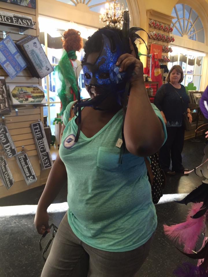 Top row: Jasmine wearing a mask in a shop, a photo of the French Market. Bottom row: a selfie of Jasmine in front of the French market, a photo of Decatur written on the street.