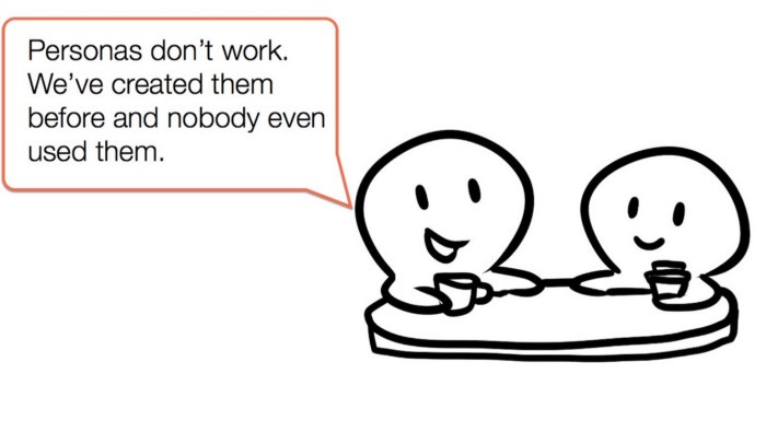 Two people sitting at a table. One person says “Personas don’t work. We’ve created them before and nobody even used them.”