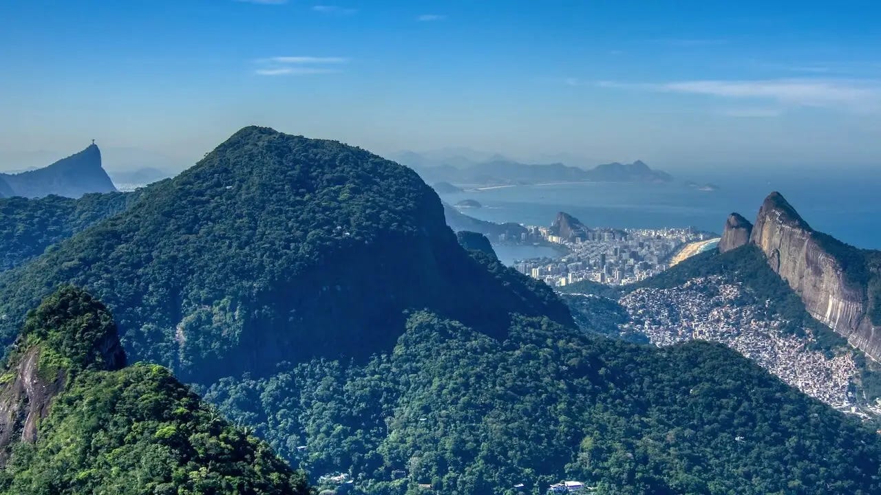  Rainforest-covered hillsides leading down to beaches and blue sea