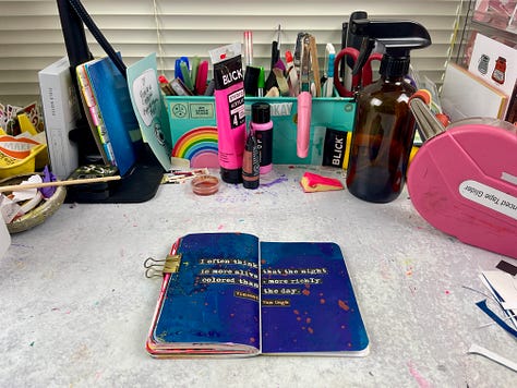 Various art journal pages in a small notebook
