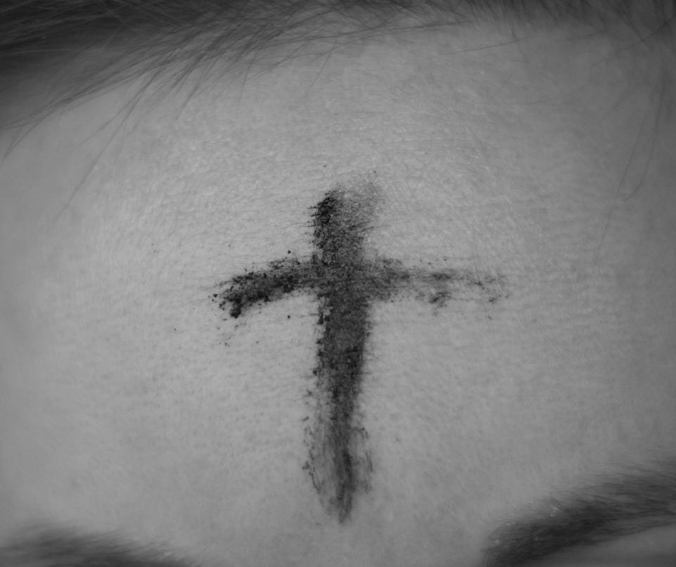 cross on person's forehead