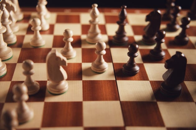 Wooden chess pieces on a chessboard, strategic game concept. Brainstorming and analytical thinking challenge. Board game entertainment. Wooden chess pieces on a chessboard, strategic game concept. Brainstorming and analytical thinking challenge. Board game entertainment.
