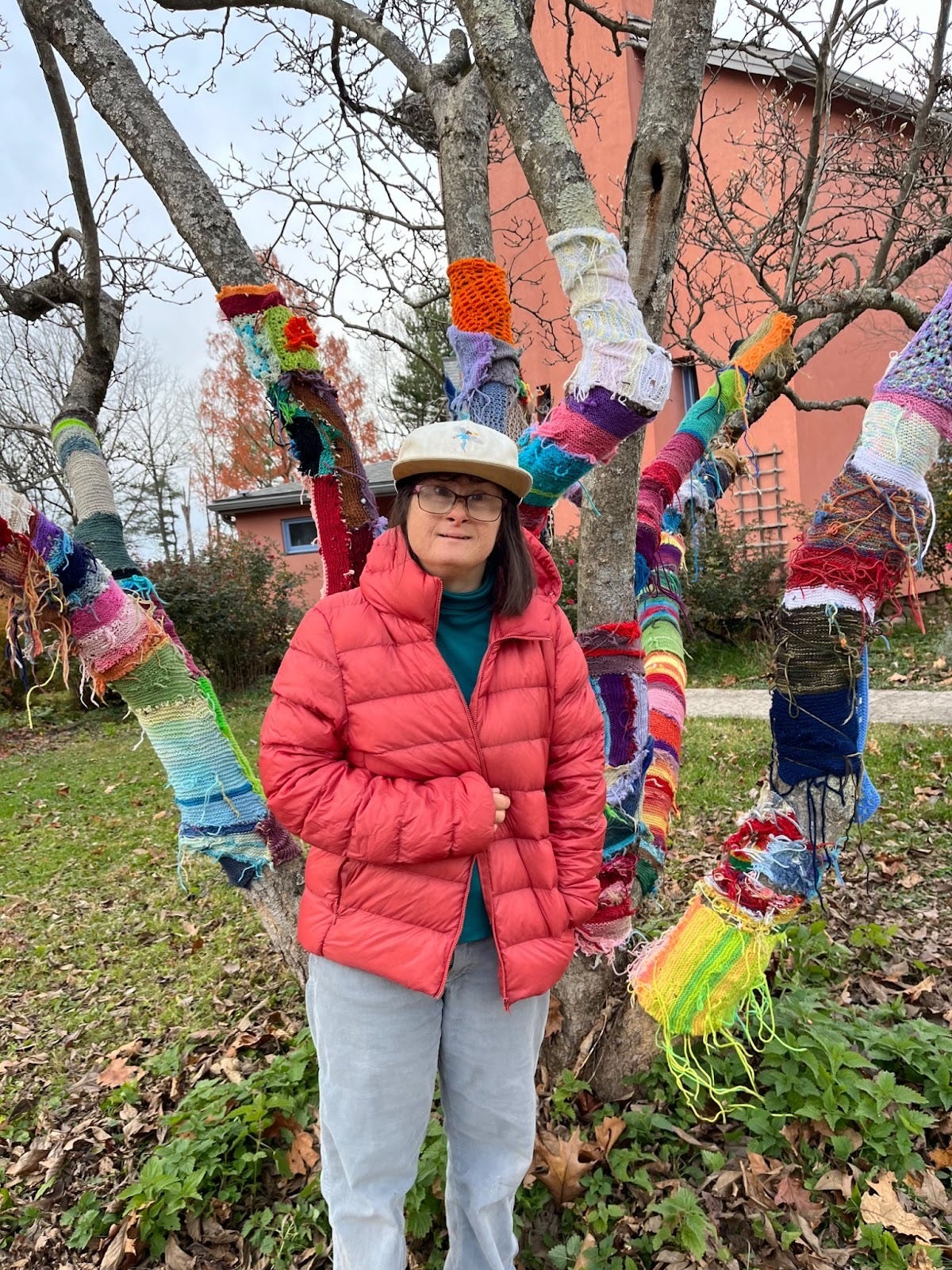 Mary poses in front of this year's iteration of her Yarn Tree.  We appreciate its color in the winter landscape.