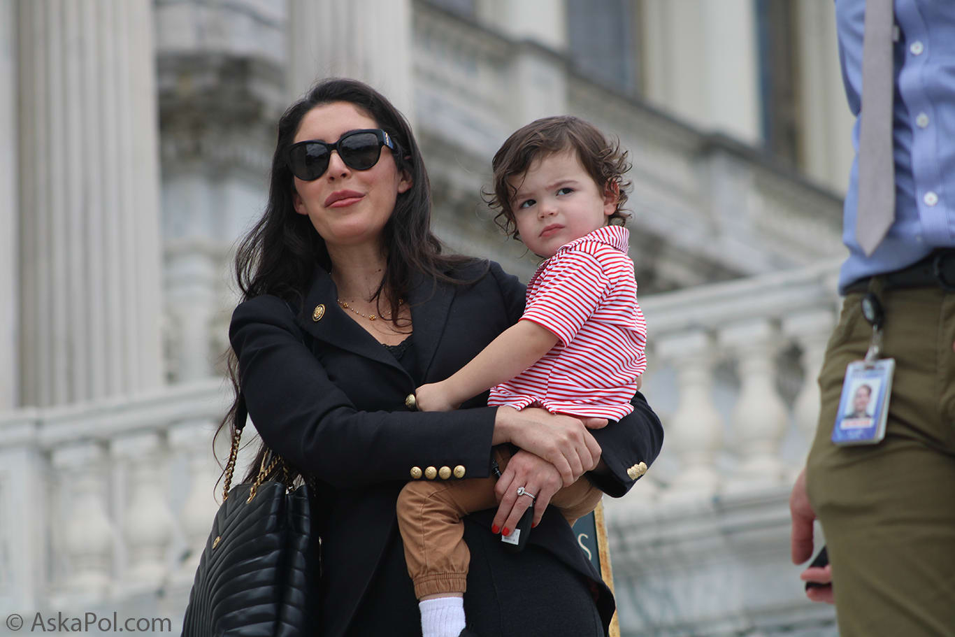 Lady in sunglasses holds young child with big greek columns in background Photo: Logan Johnson © AskaPol.com Lady in sunglasses holds young child with big greek columns in background Photo: Logan Johnson © AskaPol.com