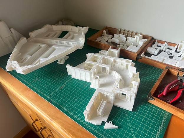 A group of white model buildings on a green surface

AI-generated content may be incorrect.