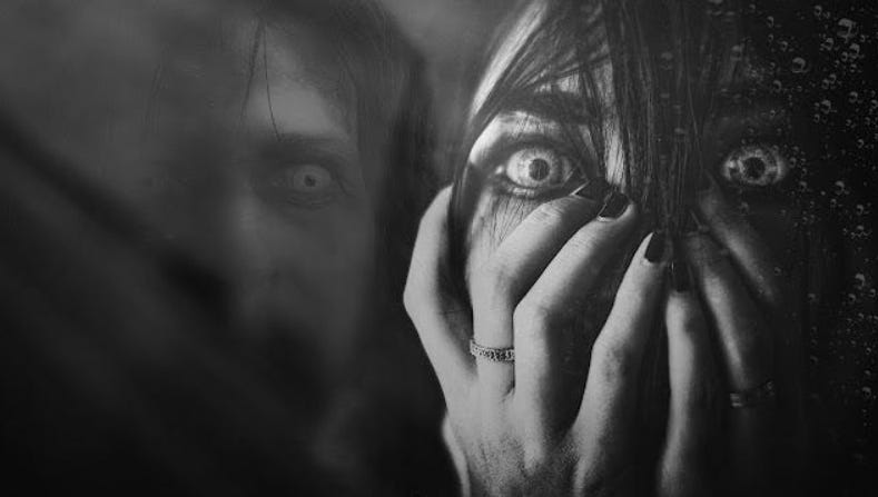 A dark, eerie black and white composite image of a terrified woman behind rain-streaked glass, juxtaposed with a haunting, spectral face representing the psychological projection of the inner shadow.