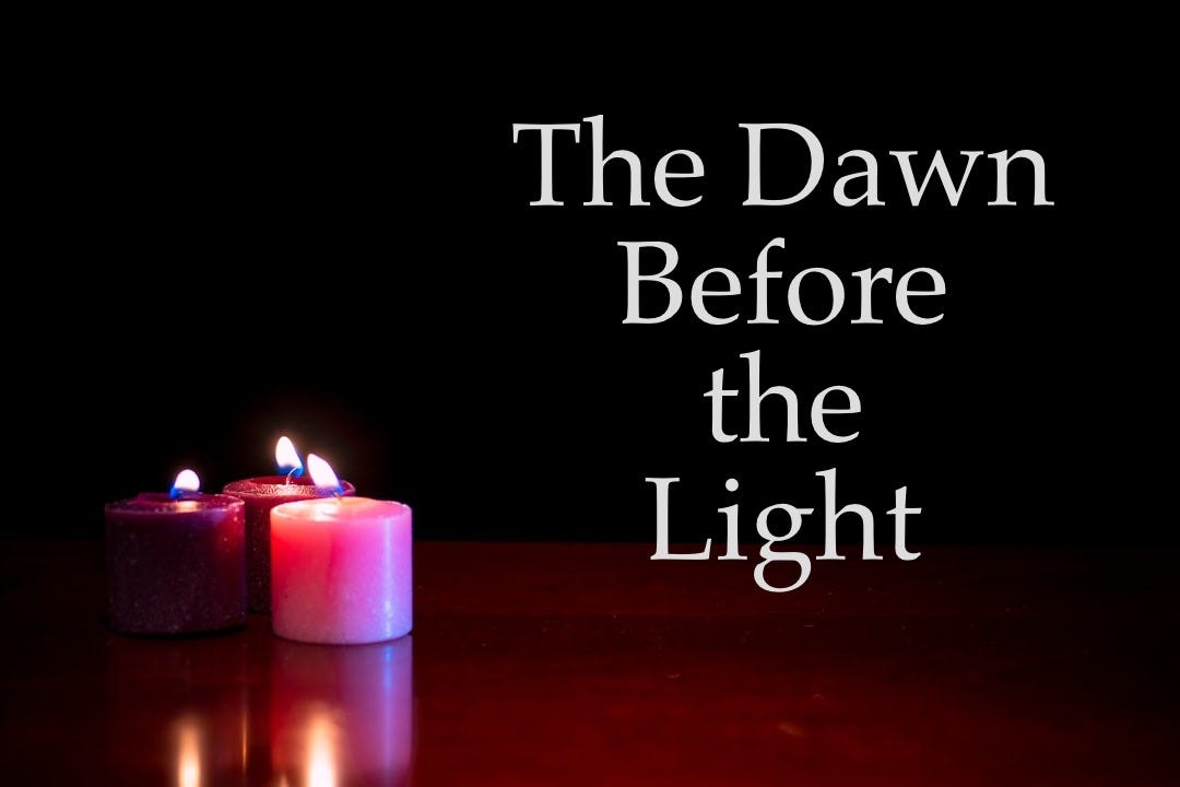 purple lighted candle on brown wooden table