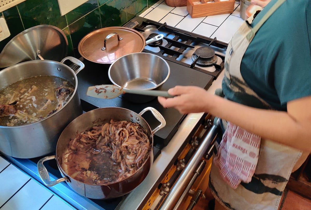 Held caramelizing onions at La Peetch