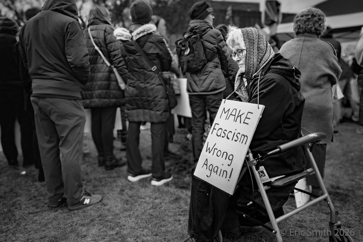 Seated woman at ICE protest at DHS regional office in Burlington, MA