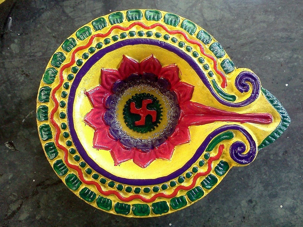 brightly painted bowl with a Hindu four armed cross in the centre brightly painted bowl with a Hindu four armed cross in the centre