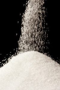 pouring sugar on a pile of sugar