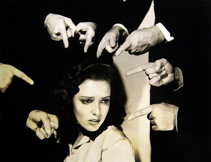 This may contain: black and white photograph of a woman getting her hair done by several people holding their hands up