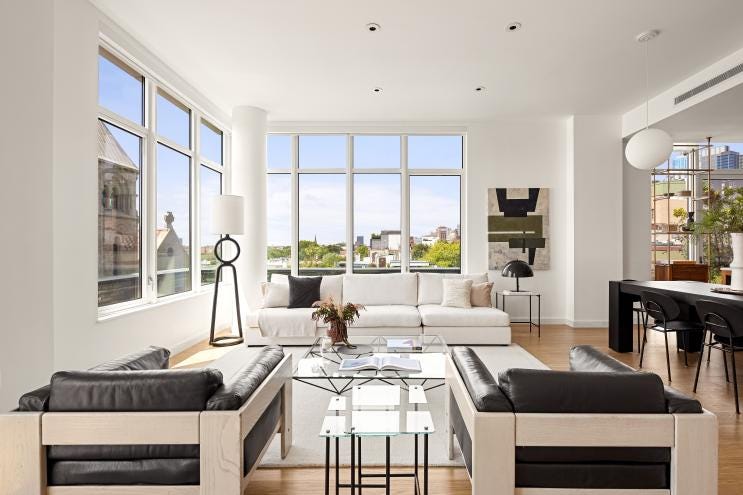 His 2,400 sq ft residence spans the top two floors of "The Hendrik", a Mid-Century Modern building, and features a wrap-around terrace with panoramic views of Brooklyn and New York Harbor.