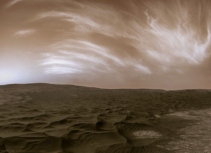 a martian suface featuring sandy dunes and a cloudy noctilucent sky