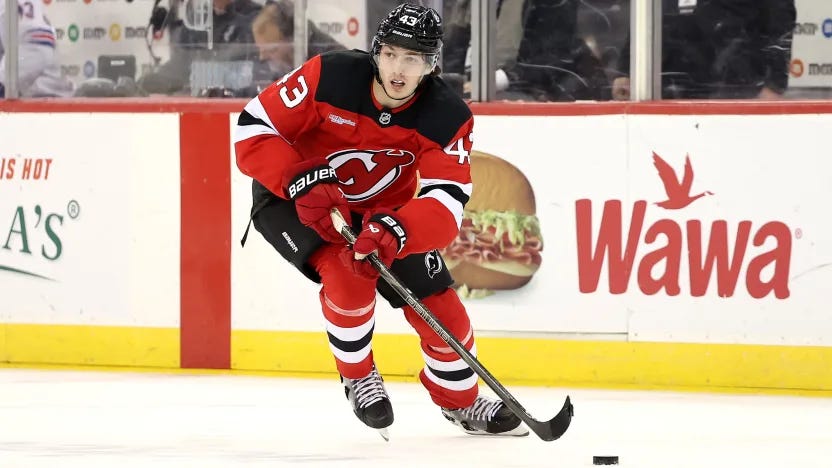 Luke Hughes carrying the puck