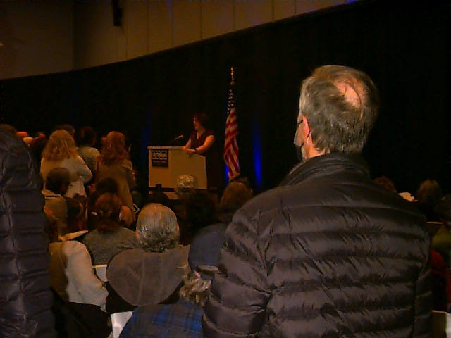 An extremely poorly lit shot of a political rally, with me on stage. An extremely poorly lit shot of a political rally, with me on stage.
