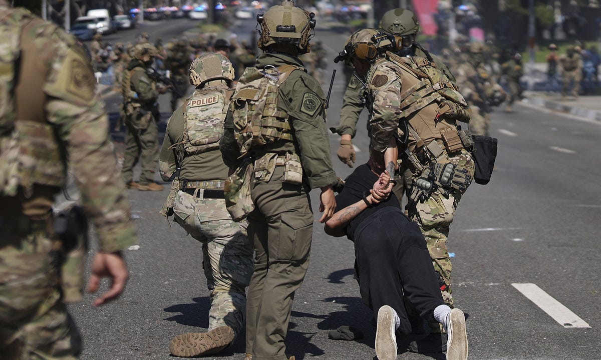 Police detain a man during a protest in the Paramount section of Los Angeles, on June 7, 2025, after federal immigration authorities conducted operations.  Photo: CFP