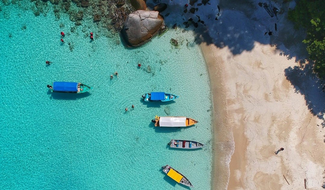 aerial view photography of boats on seashore aerial view photography of boats on seashore
