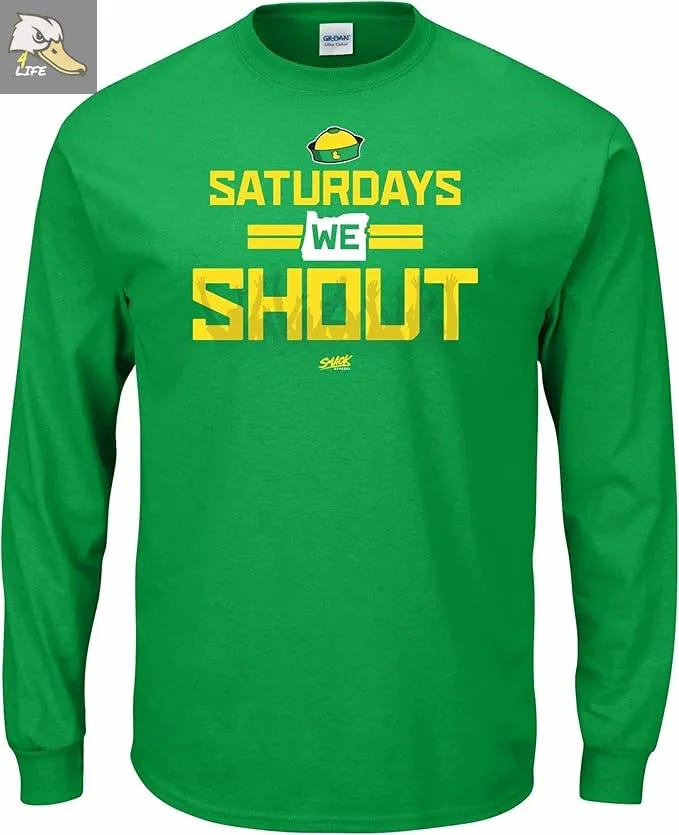 Green long-sleeve Oregon Ducks “Saturdays We Shout” shirt with bold yellow text and Oregon state map outline design, perfect for game day fans. Deals on seats, fan gear, and premium content at www.Ducks4.Life