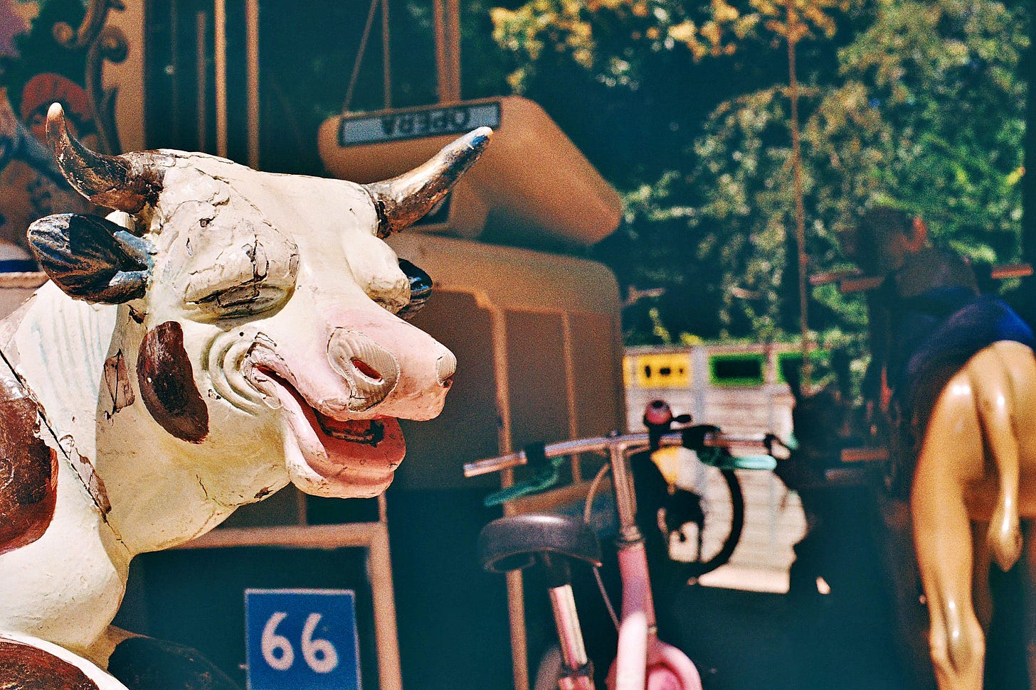 a smarmy, early 20th-century cow on a carousel, eyes closed and seeming a little high