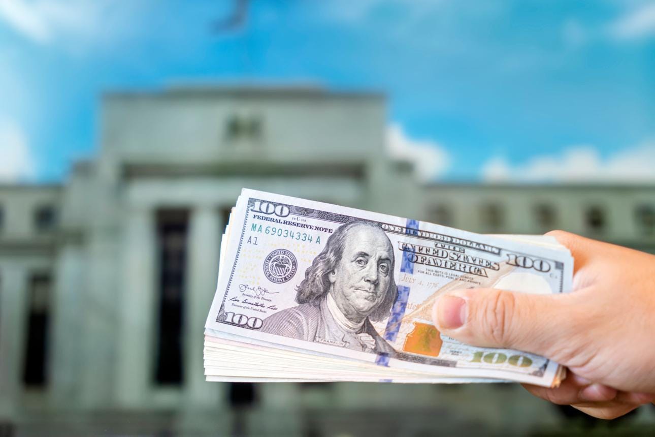 a hundred-dollar bill on the background central bank. Federal Reserve Building in Washington United States a hundred-dollar bill on the background central bank. Federal Reserve Building in Washington United States