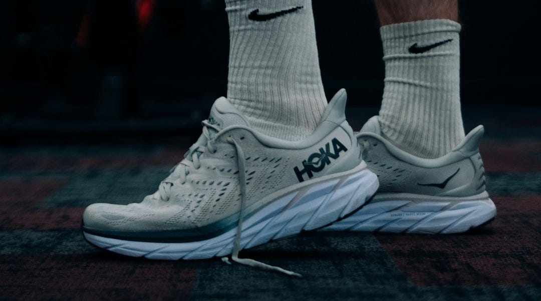 a close up of a person's feet wearing nike shoes a close up of a person's feet wearing nike shoes