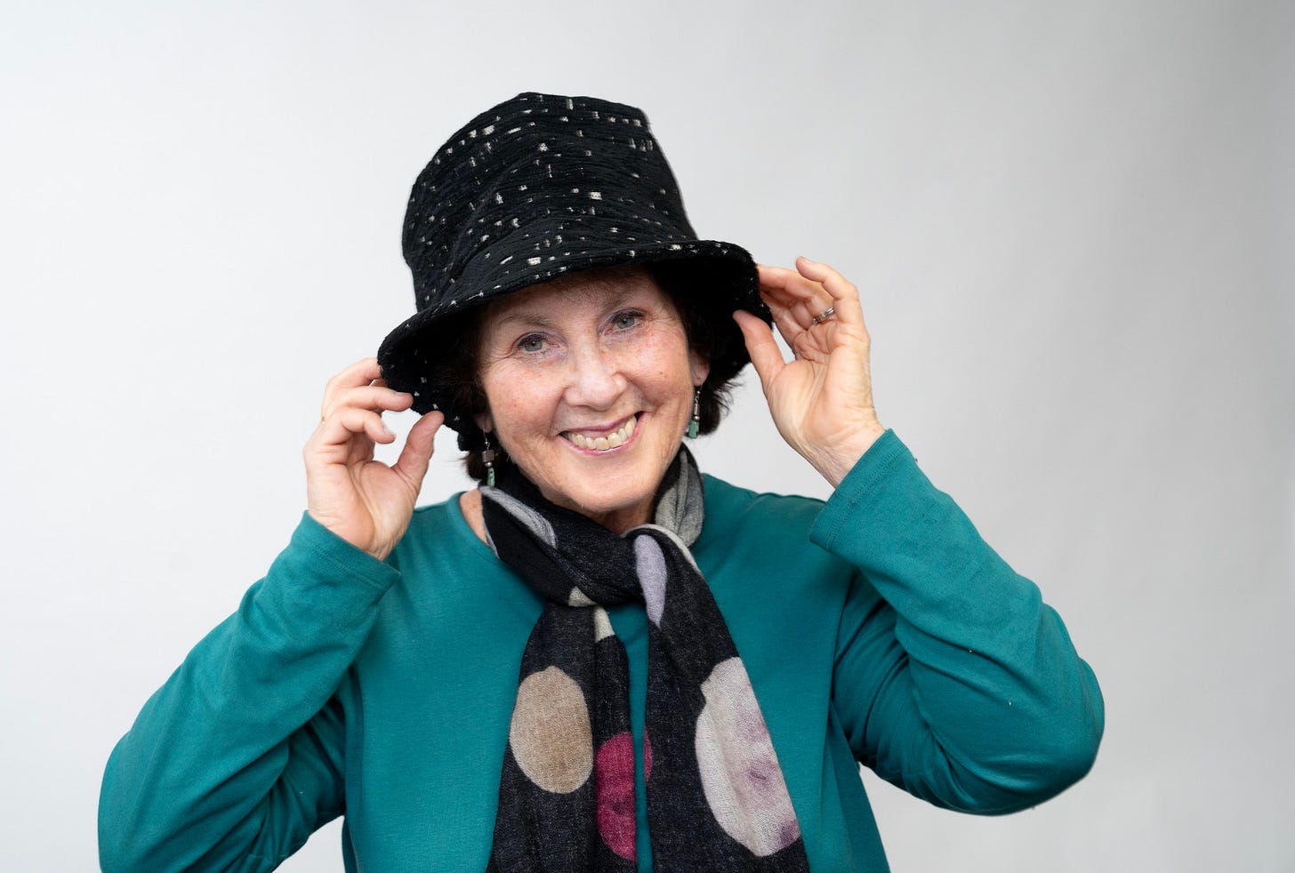 May be an image of 1 person, smiling, scarf and hat