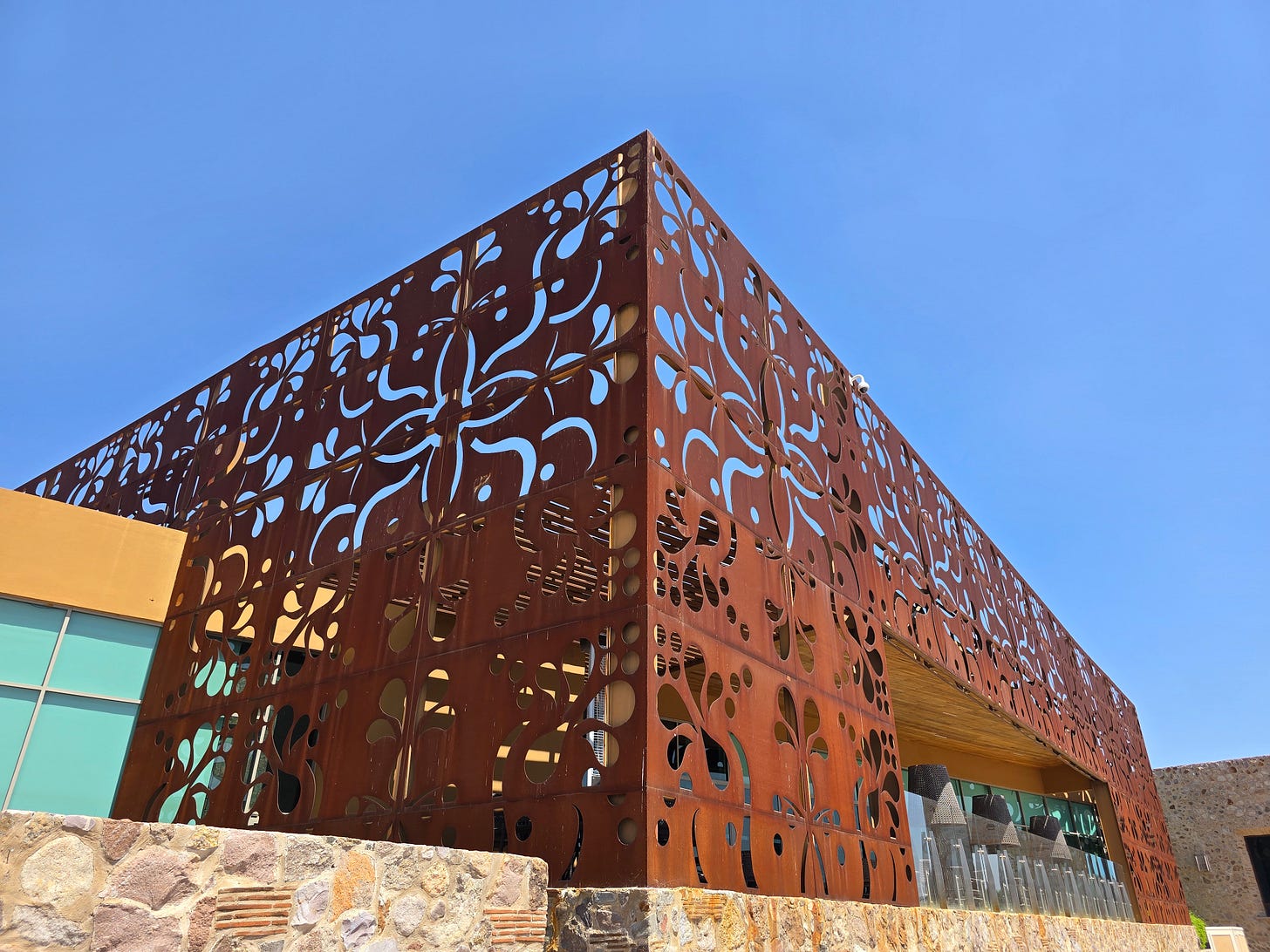 metal decor in a rust color in front of a blue sky