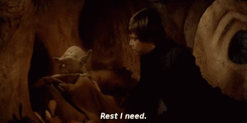 a man is standing next to a monster in a cave and says `` rest i need . ''