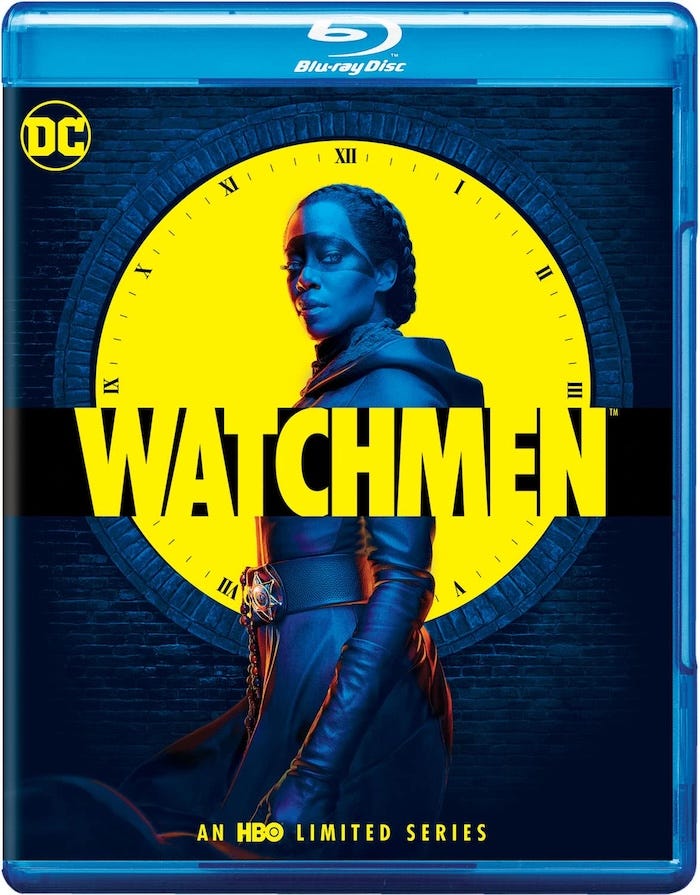 Blu-ray packaging for Watchmen (2019) featuring Regina King as Sister Night, standing in front of a bright yellow clock face with Roman numerals. The iconic WATCHMEN title stretches across the cover in bold black letters. A DC logo and Blu-ray Disc logo are present. Blu-ray packaging for Watchmen (2019) featuring Regina King as Sister Night, standing in front of a bright yellow clock face with Roman numerals. The iconic WATCHMEN title stretches across the cover in bold black letters. A DC logo and Blu-ray Disc logo are present.
