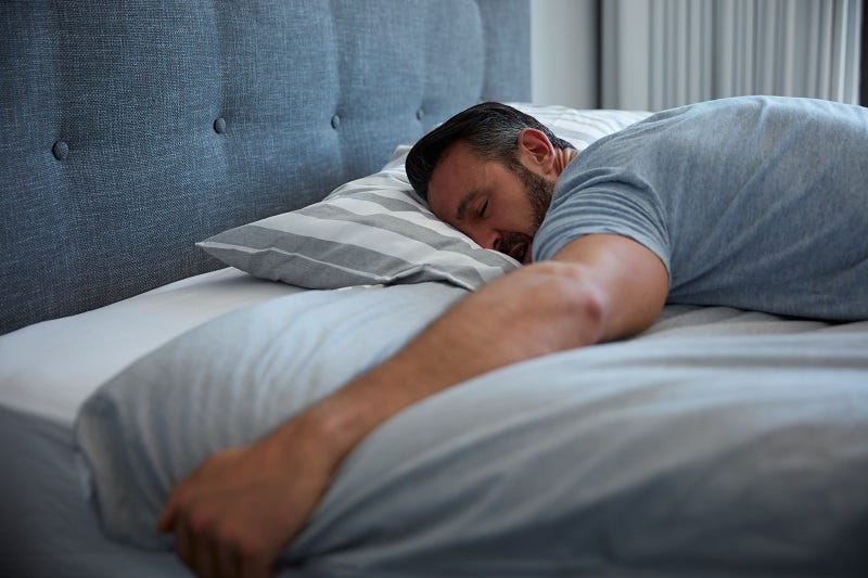 Middle aged man sleeping deeply. 